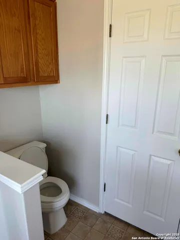 a white toilet sitting next to a shower