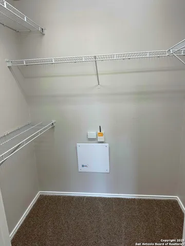 a view of storage and utility room with racks on the wall