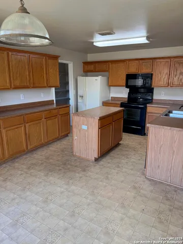 a kitchen with stainless steel appliances granite countertop a stove and a sink