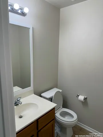 a white toilet sitting next to a bathroom sink