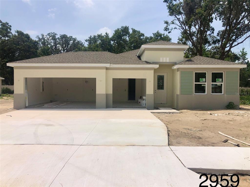 2959 Gator Xing Place New Port Richey, FL 34655 - Photo 1 of 1 a front view of a house with a yard and garage