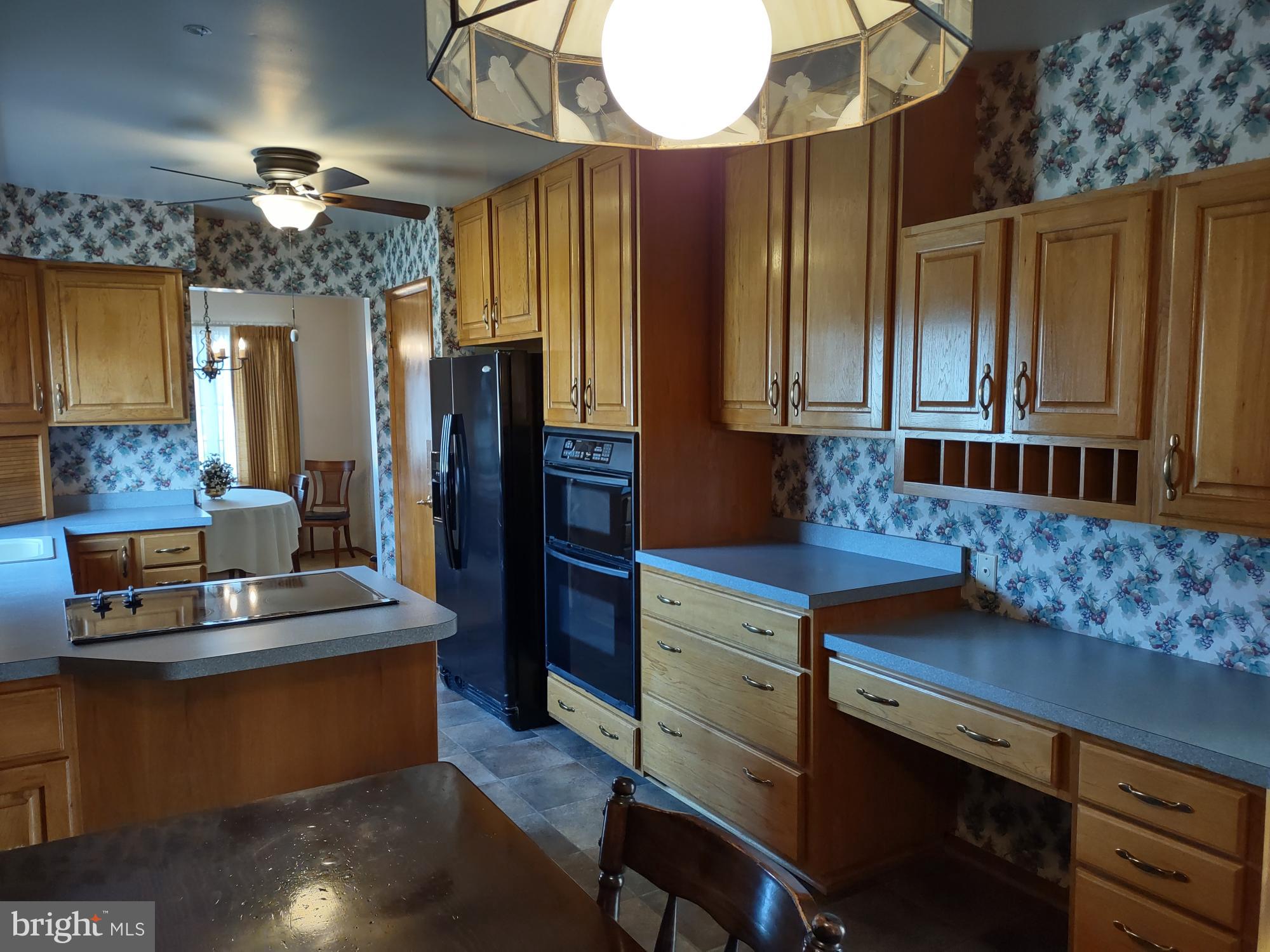 601 Rowe Drive Aberdeen, MD 21001 - Photo 17 of 52 a kitchen with kitchen island granite countertop a stove refrigerator and cabinets