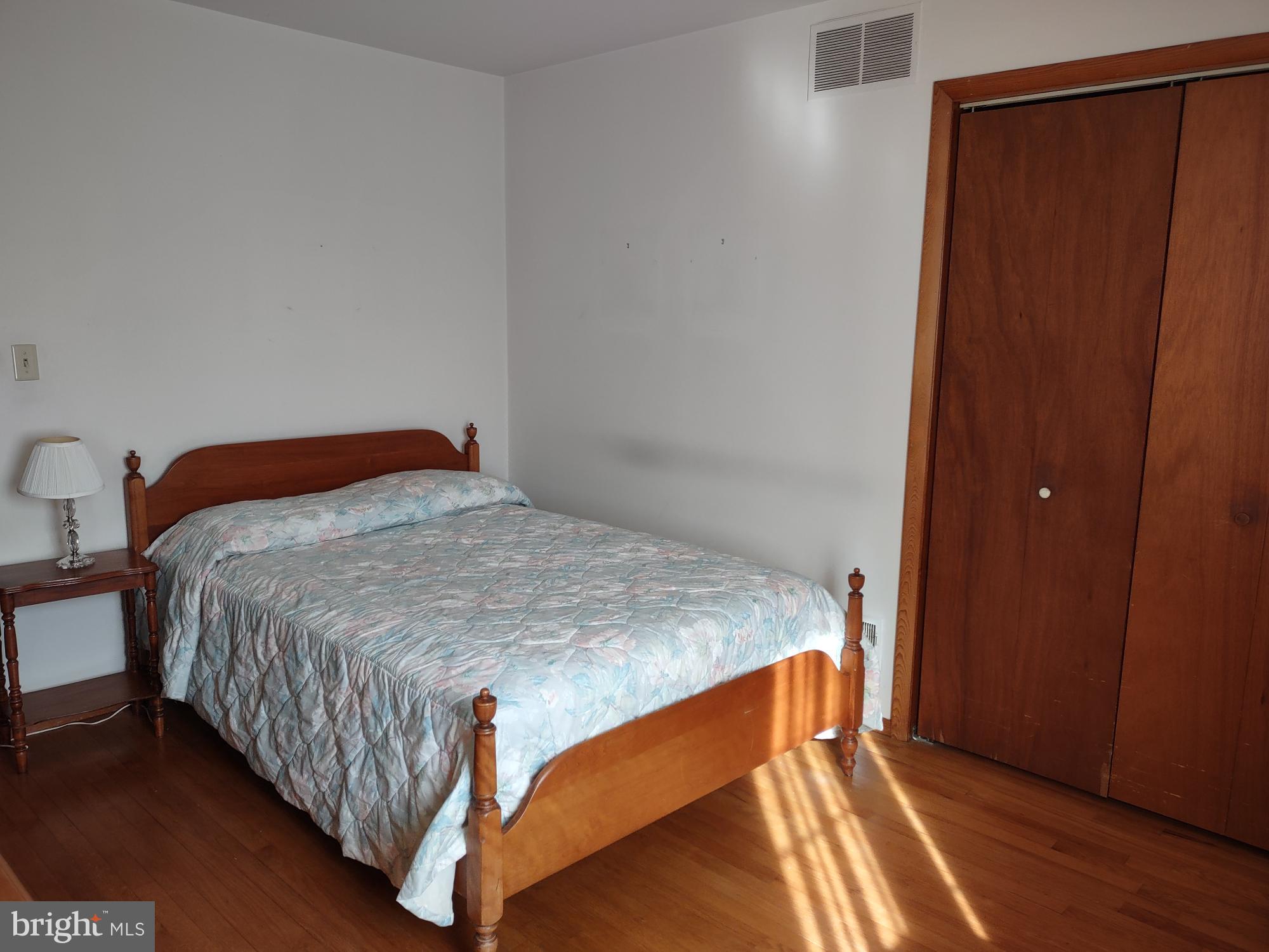 601 Rowe Drive Aberdeen, MD 21001 - Photo 39 of 52 a bedroom with a bed and wooden floor