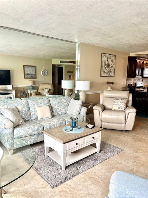 4650 Cove Circle, Unit 402 St. Petersburg, FL 33708 - Photo 15 of 36 a living room with furniture and a couch