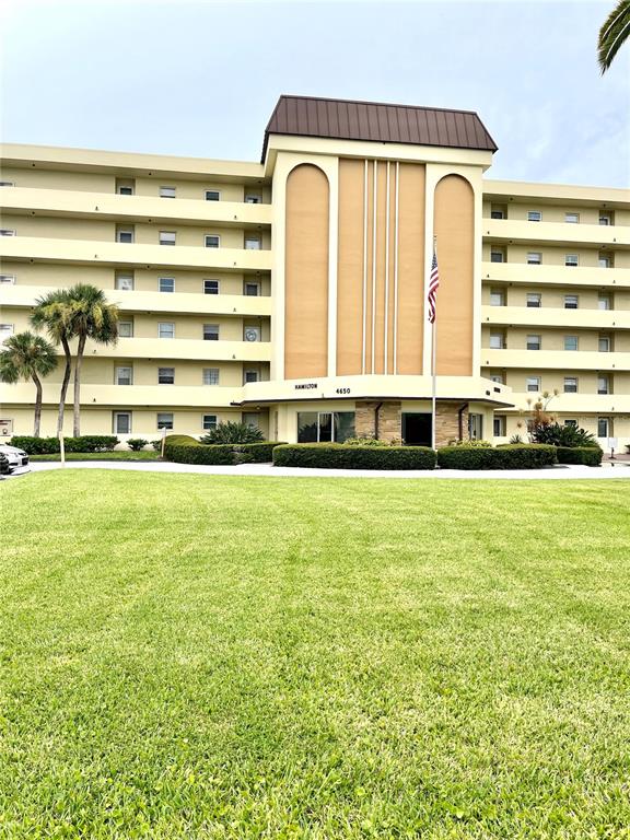 4650 Cove Circle, Unit 402 St. Petersburg, FL 33708 - Photo 2 of 36 a view of swimming pool with outdoor space and seating area