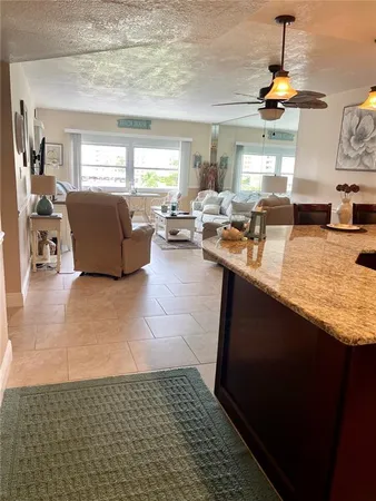 a living room with dining room and kitchen view