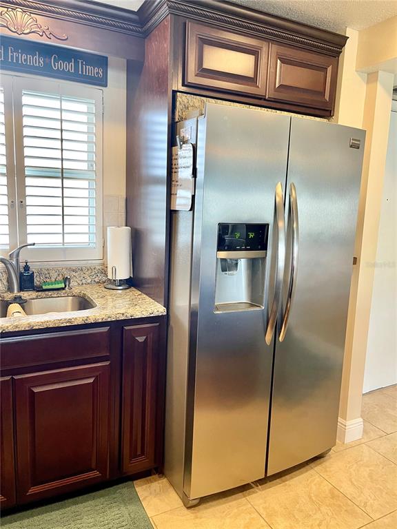 4650 Cove Circle, Unit 402 St. Petersburg, FL 33708 - Photo 6 of 36 a kitchen with stainless steel appliances granite countertop a refrigerator and a sink