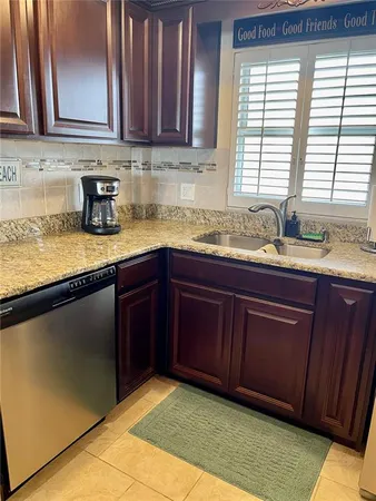 a kitchen with a sink a window and cabinets