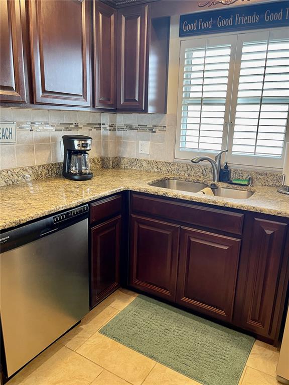 4650 Cove Circle, Unit 402 St. Petersburg, FL 33708 - Photo 8 of 36 a kitchen with a sink a window and cabinets