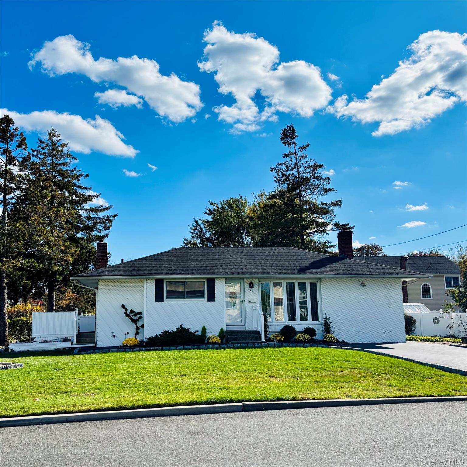 1483 4th Street West Babylon, NY 11704 - Photo 1 of 25 a front view of a house with a garden and yard