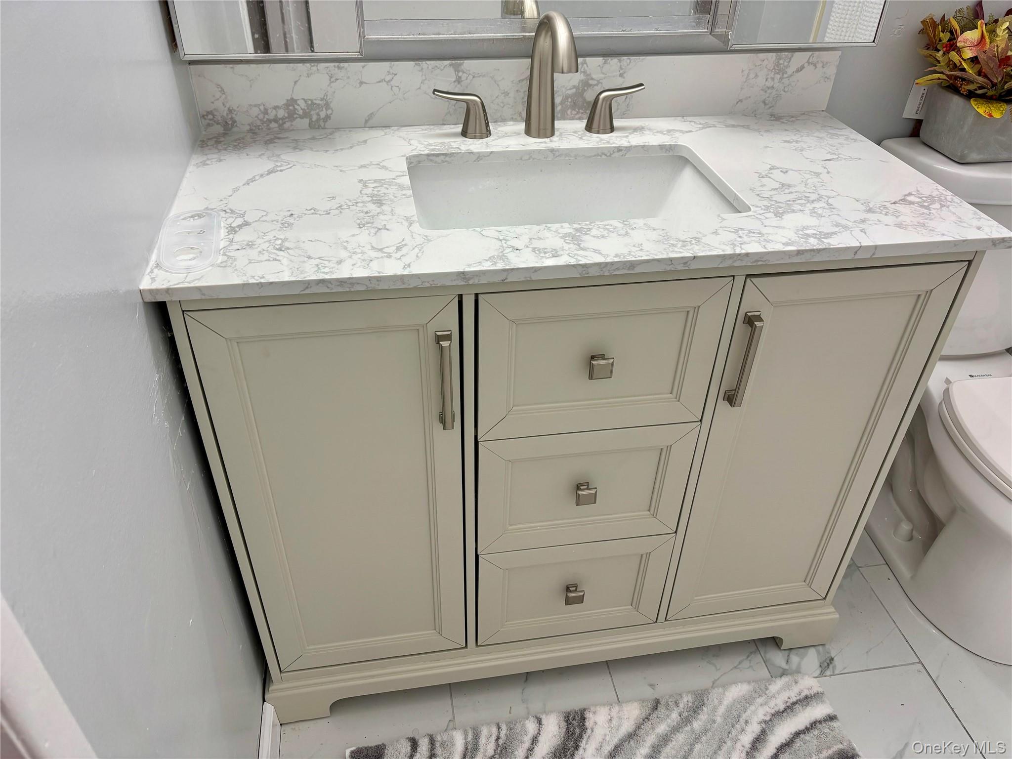 1483 4th Street West Babylon, NY 11704 - Photo 10 of 25 a bathroom with a sink and vanity