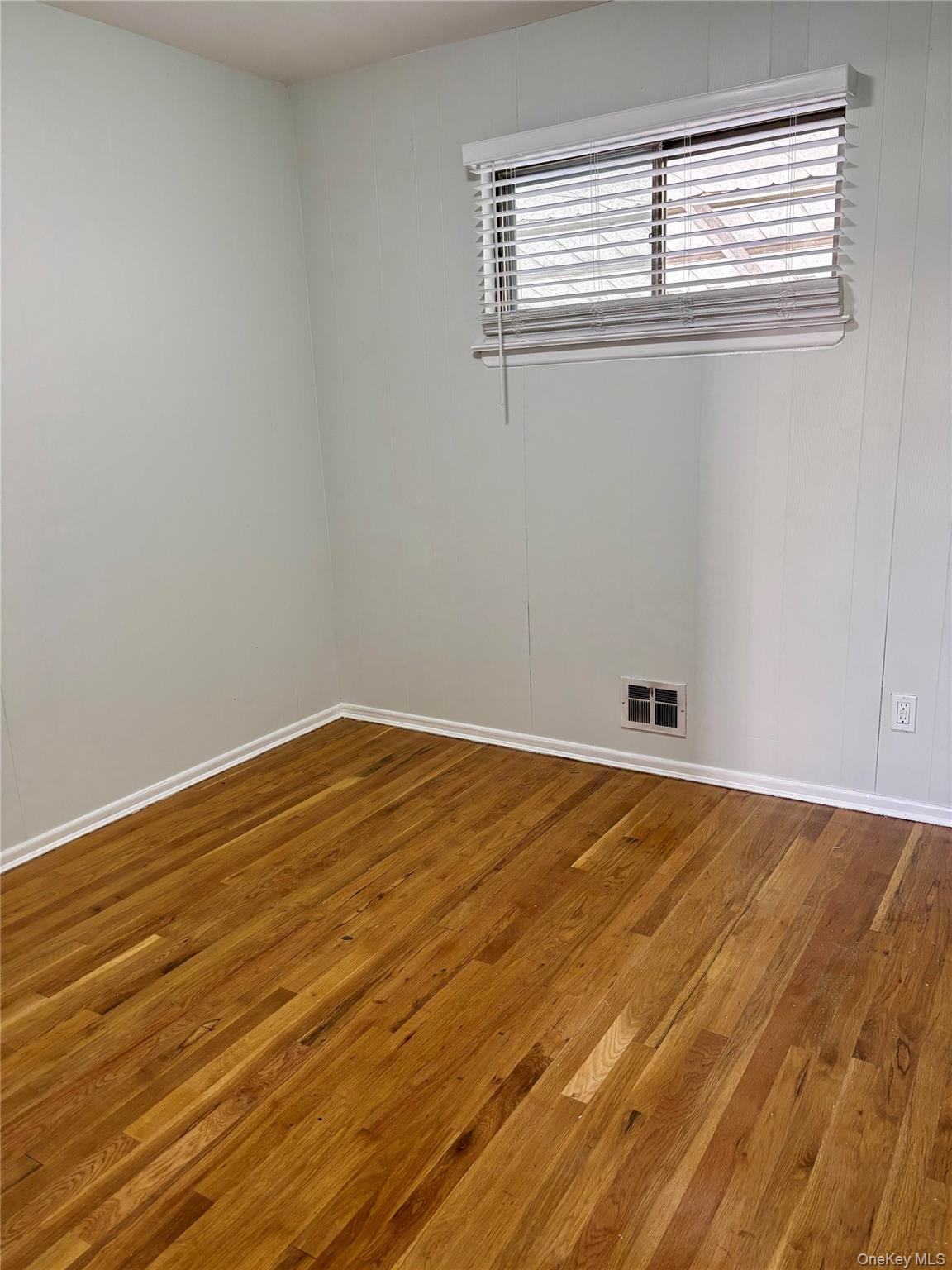 1483 4th Street West Babylon, NY 11704 - Photo 13 of 25 a view of empty room with wooden floor and fan