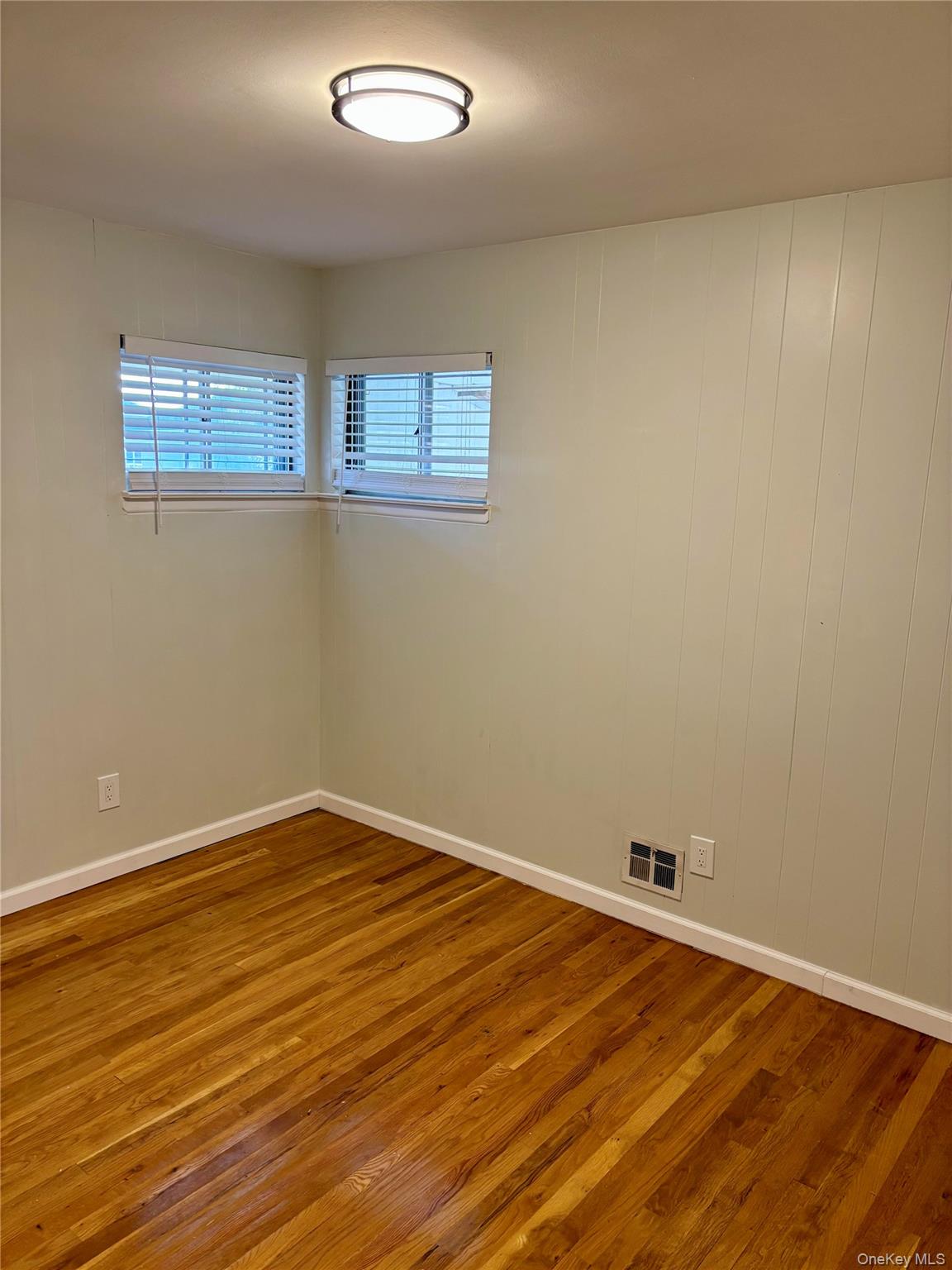 1483 4th Street West Babylon, NY 11704 - Photo 15 of 25 a view of a room with wooden floor and white walls