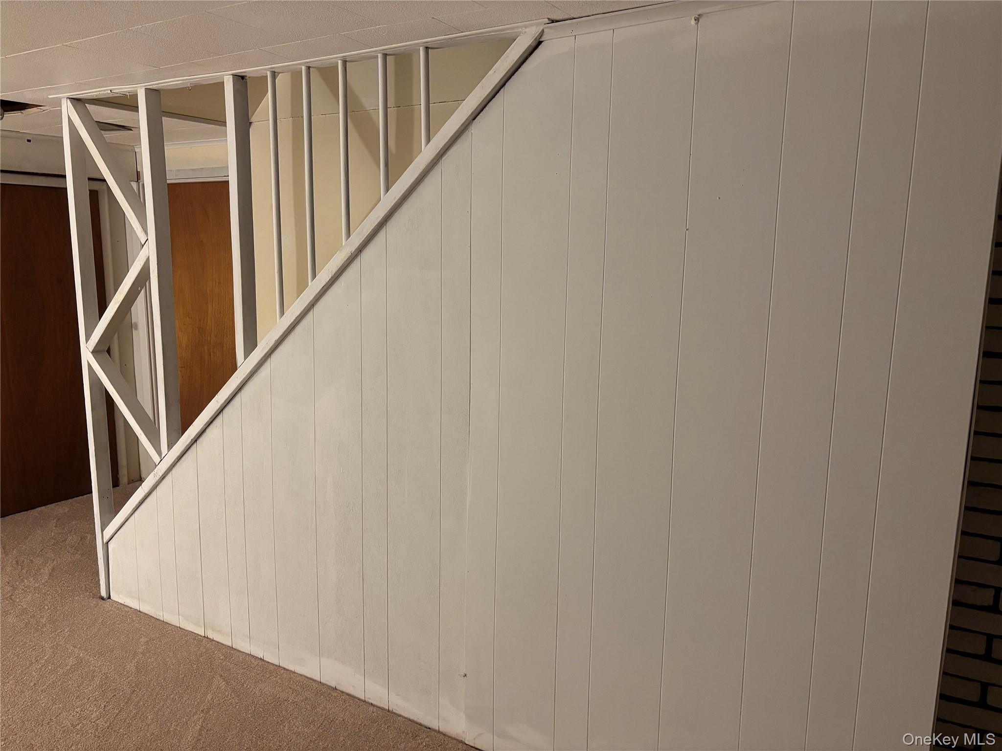 1483 4th Street West Babylon, NY 11704 - Photo 16 of 25 a view of staircase with wooden floor and white walls