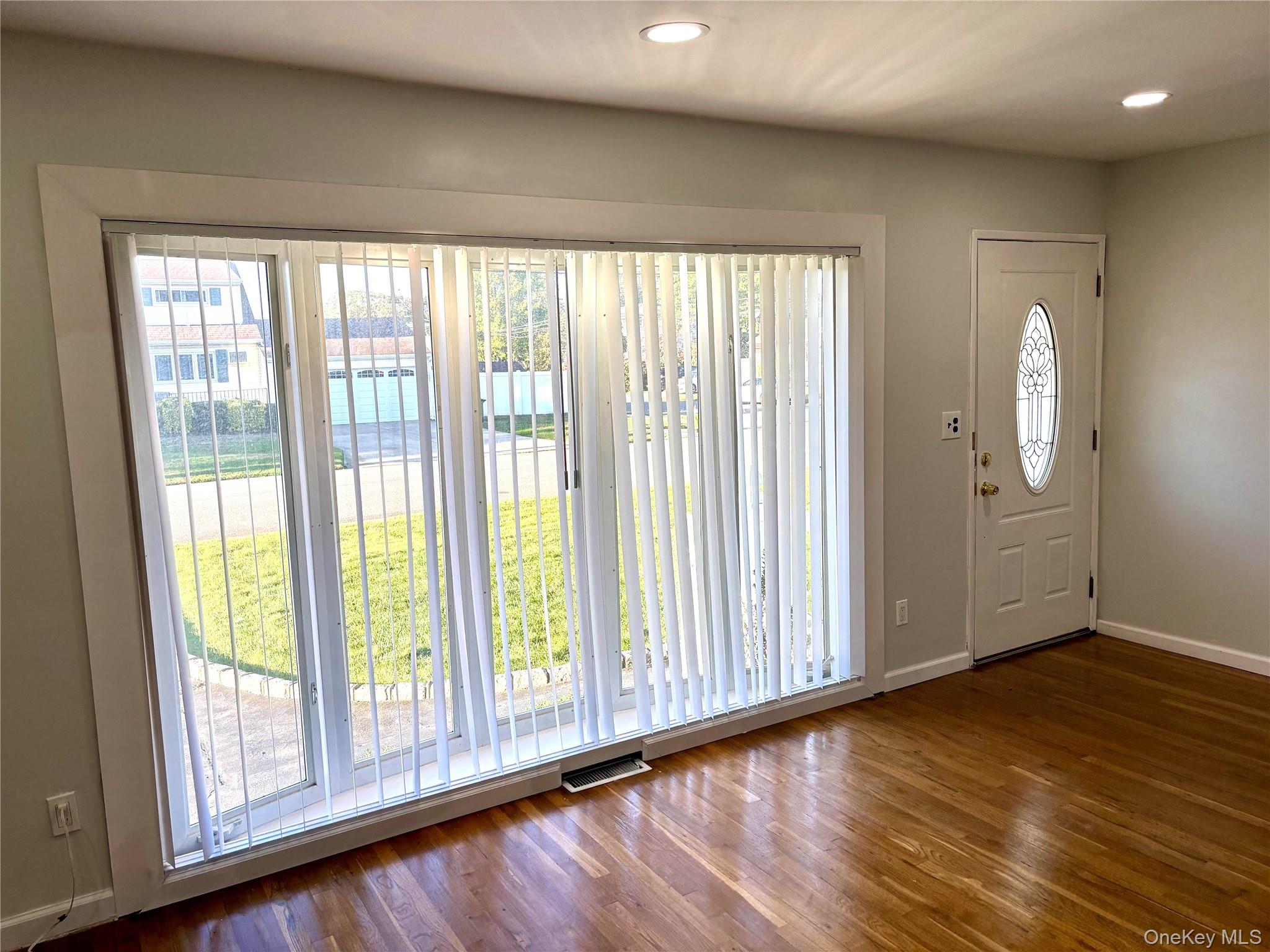 1483 4th Street West Babylon, NY 11704 - Photo 2 of 25 a view of a room with wooden floor and windows
