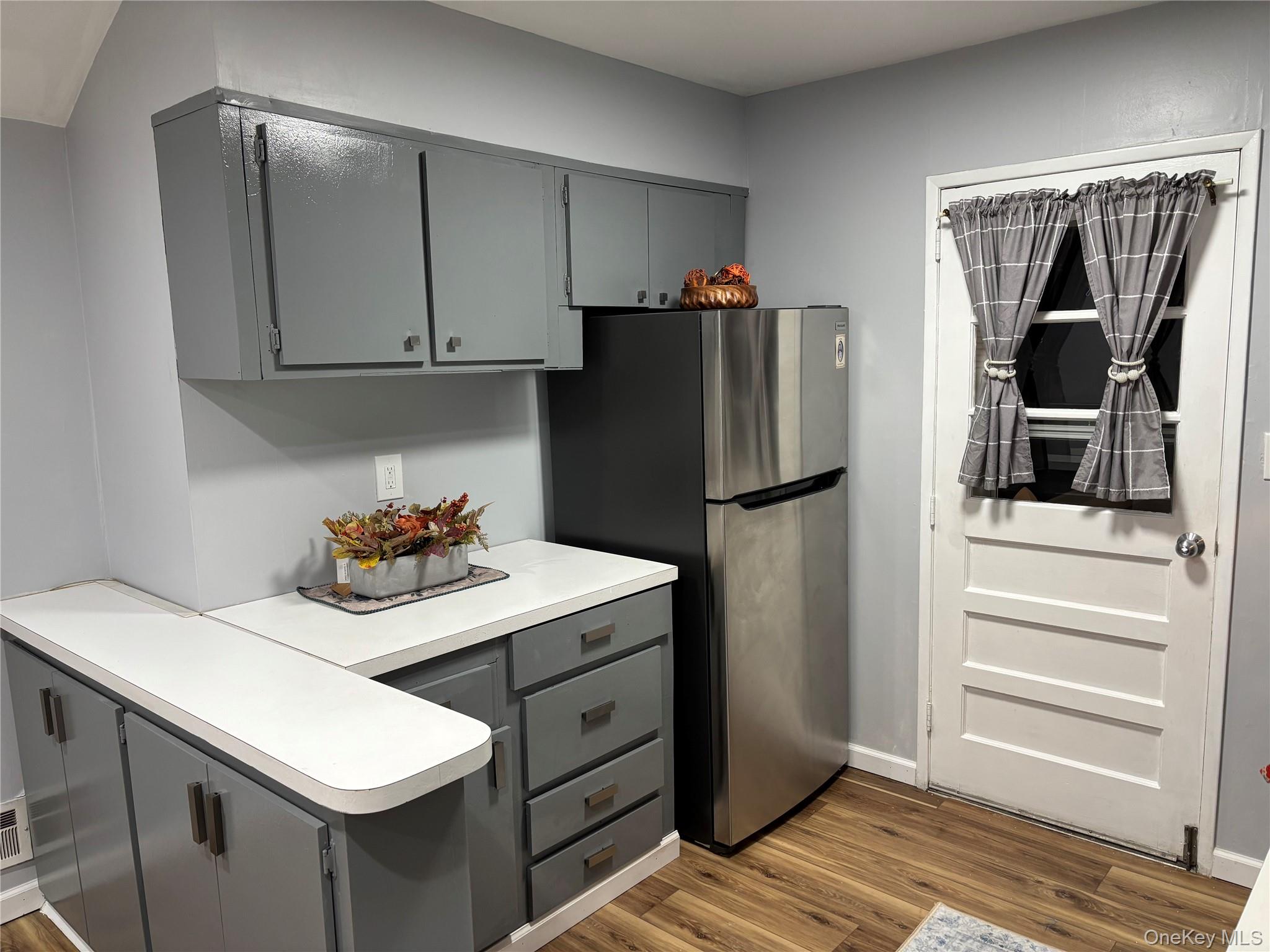 1483 4th Street West Babylon, NY 11704 - Photo 6 of 25 a kitchen with a refrigerator and cabinets