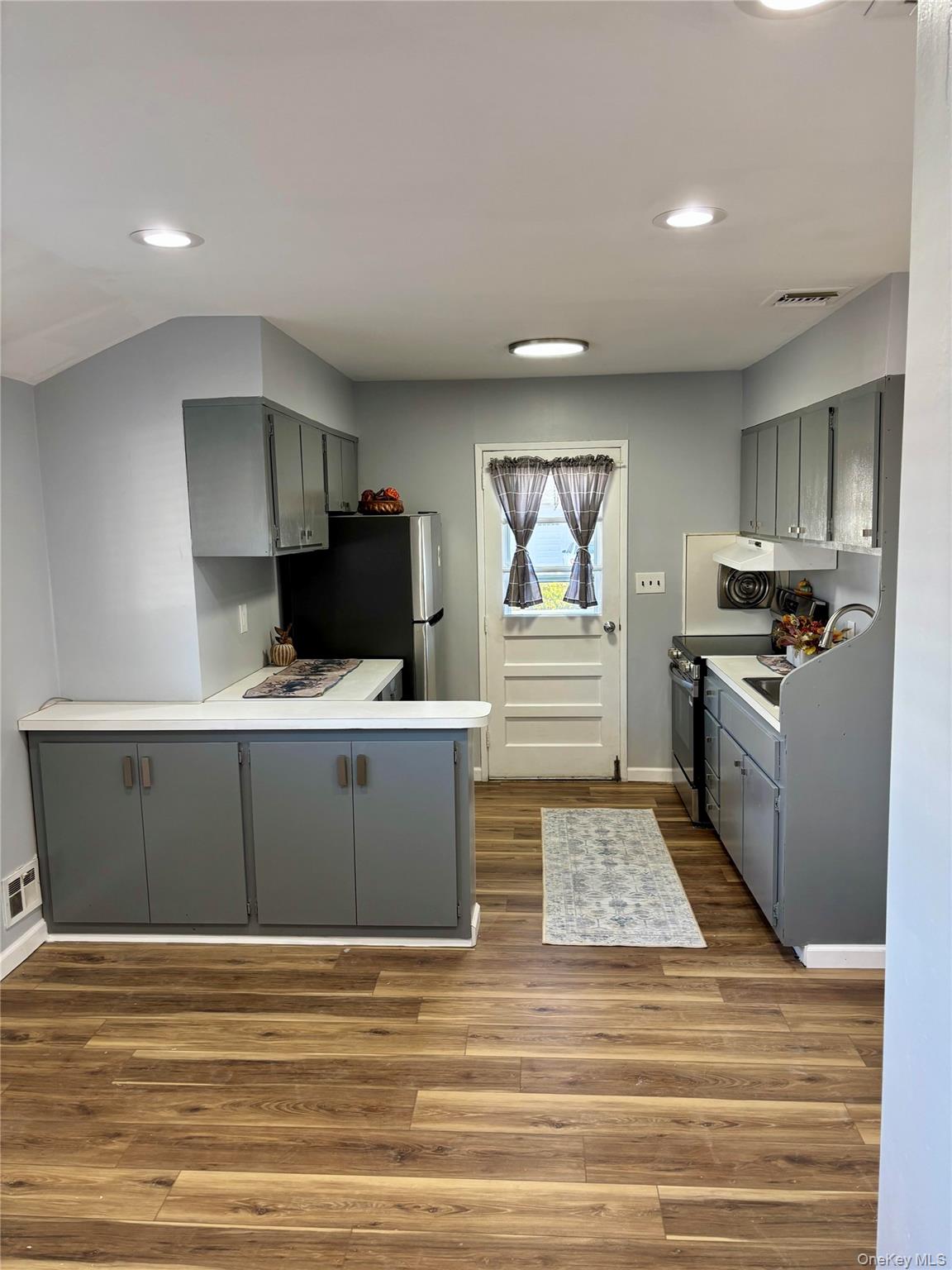 1483 4th Street West Babylon, NY 11704 - Photo 24 of 25 a kitchen with stainless steel appliances wooden cabinets and a counter top space