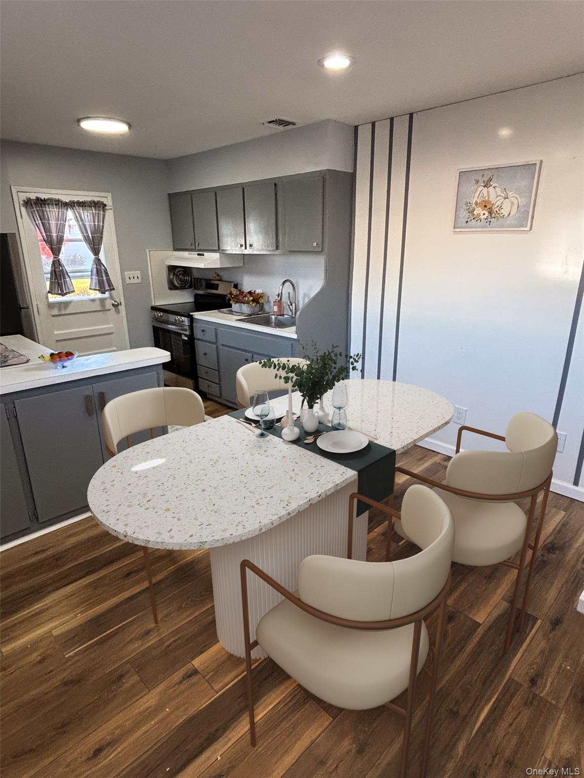 1483 4th Street West Babylon, NY 11704 - Photo 25 of 25 a kitchen with stainless steel appliances a dining table and chairs