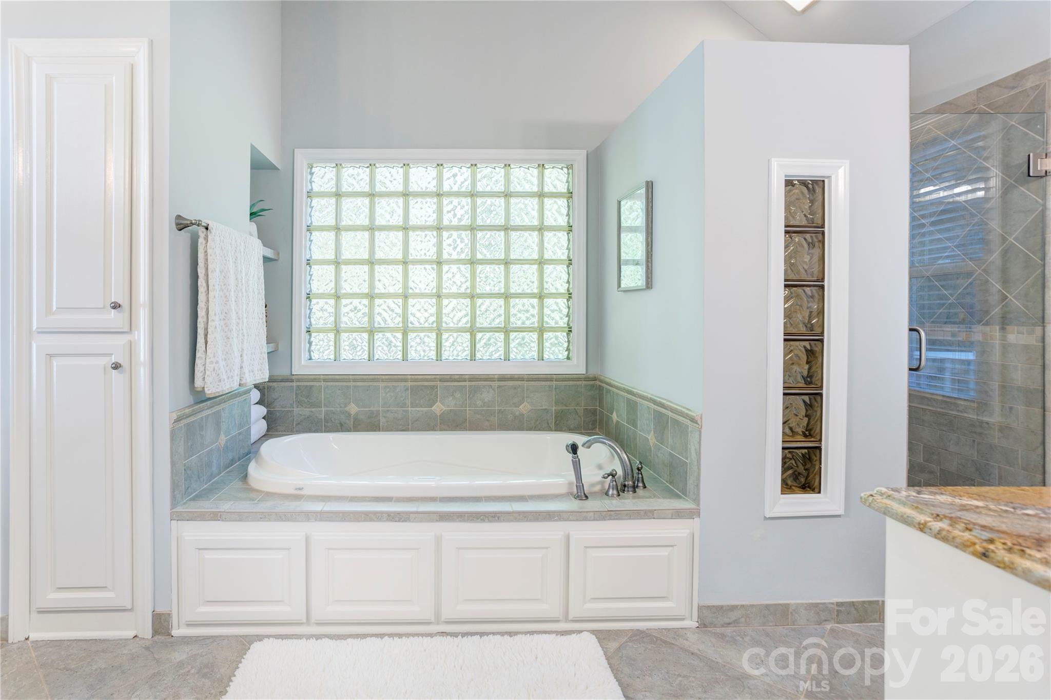 1188 Fawn Ridge Road Northwest Concord, NC 28027 - Photo 22 of 38 a bathroom with a bathtub and a shower