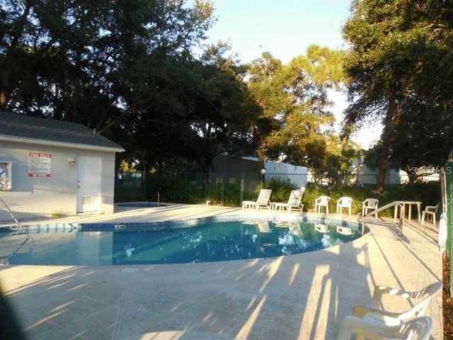 a view of a swimming pool with an outdoor space and seating area