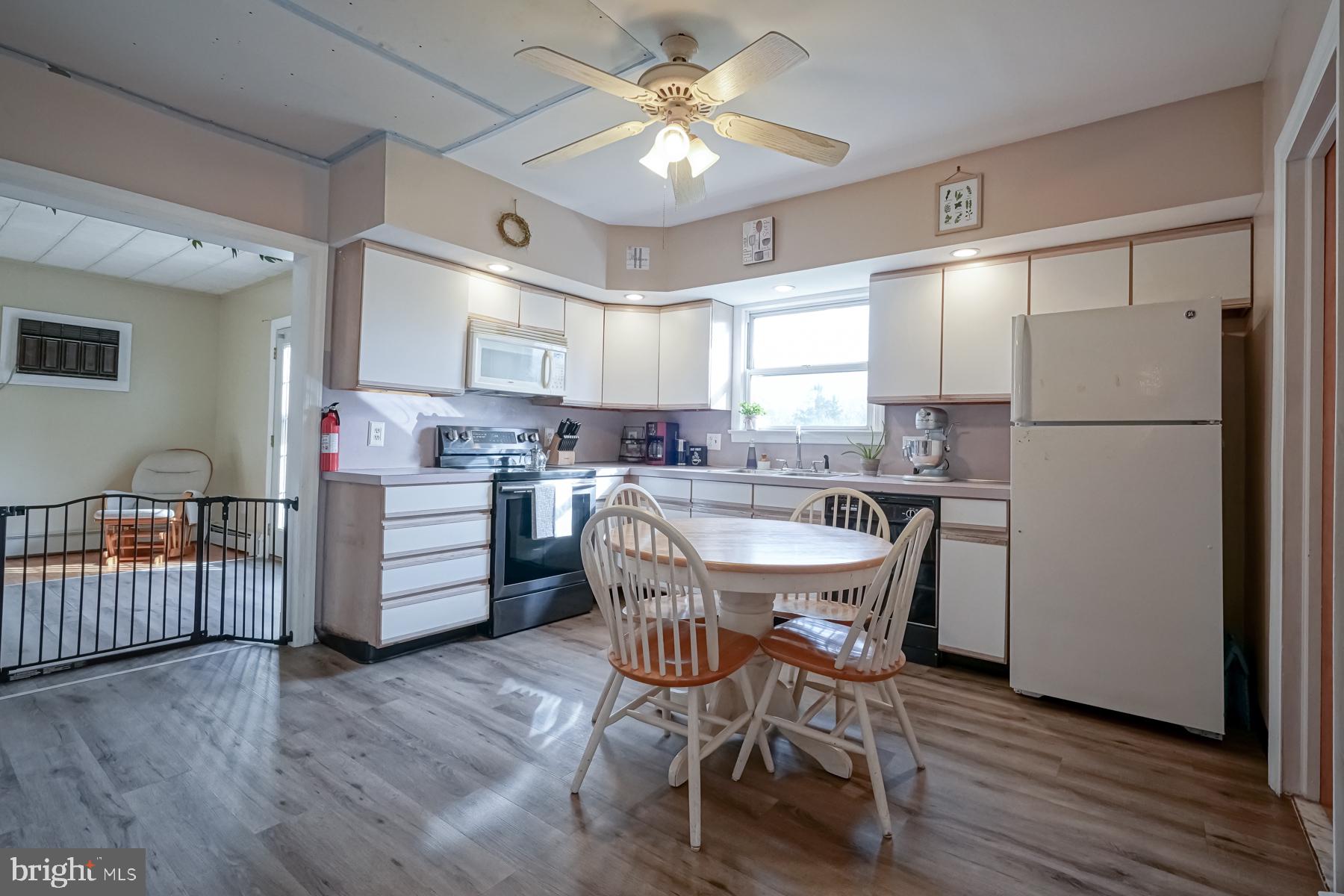 124 North 1st Road Hammonton, NJ 08037 - Photo 15 of 29 a kitchen with stainless steel appliances a refrigerator a sink dishwasher a dining table and chairs with wooden floor
