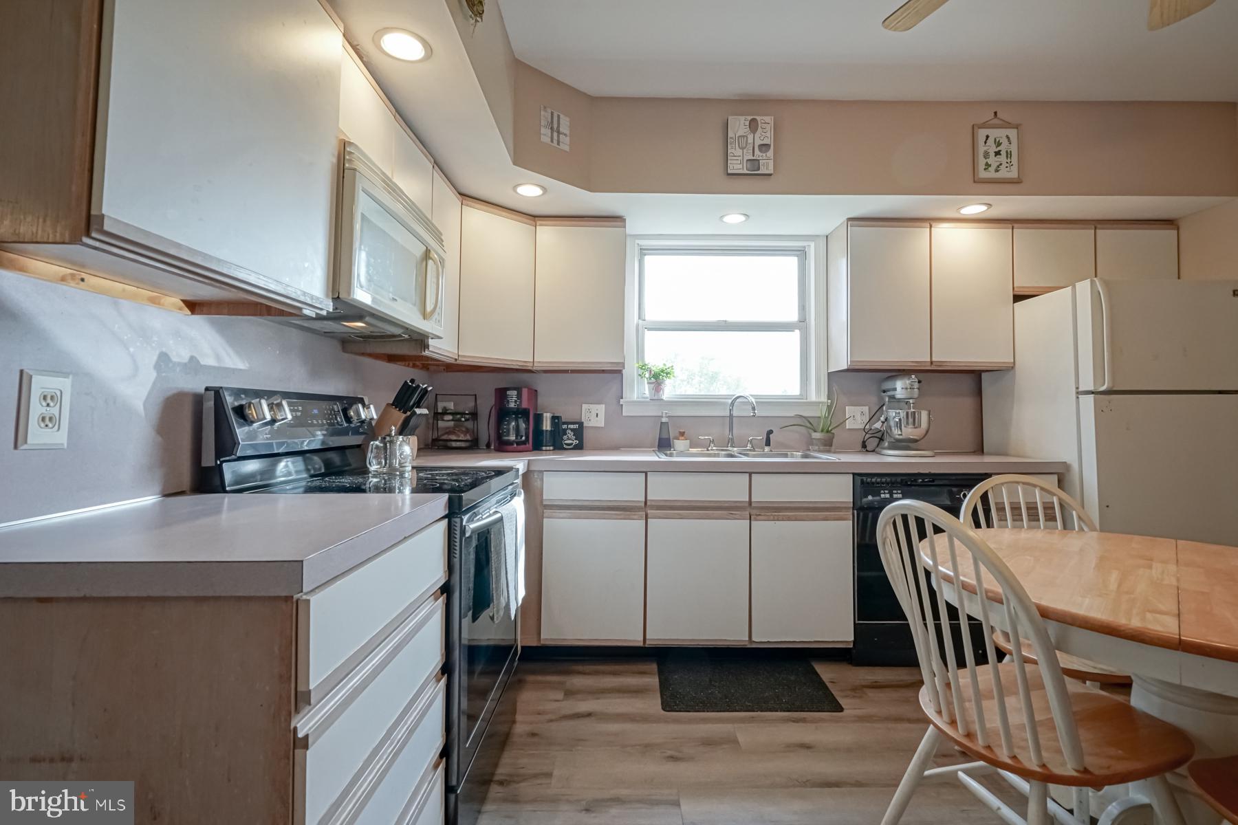 124 North 1st Road Hammonton, NJ 08037 - Photo 16 of 29 a kitchen with a table chairs a sink dishwasher window and cabinets