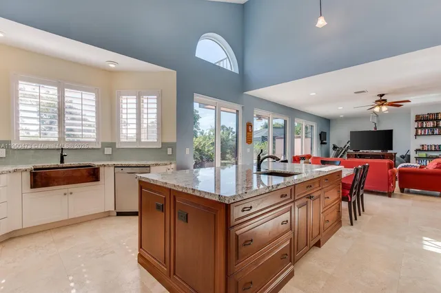 a large kitchen with kitchen island a sink stove and a dining table