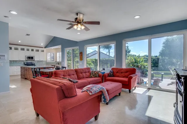 a living room with furniture and a large window