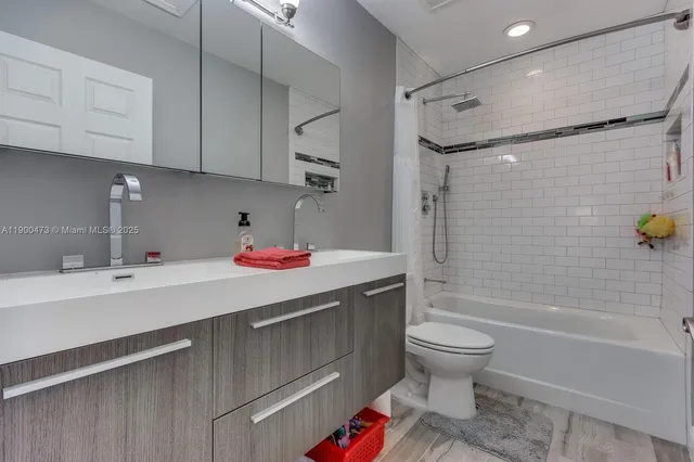 a bathroom with a sink toilet and shower