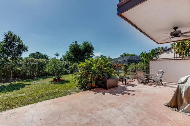a view of a backyard with sitting area