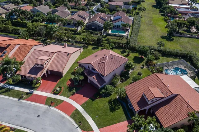 an aerial view of residential houses with outdoor space