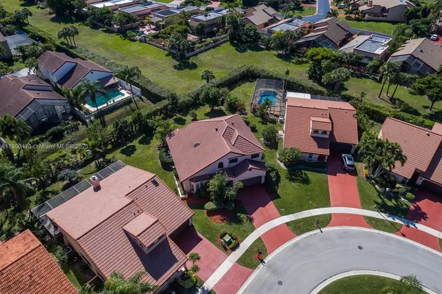 an aerial view of residential houses with outdoor space