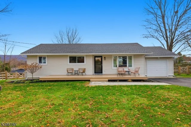 a front view of a house with a garden and patio