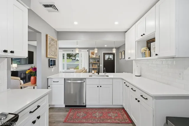 a kitchen with a sink stove and cabinets