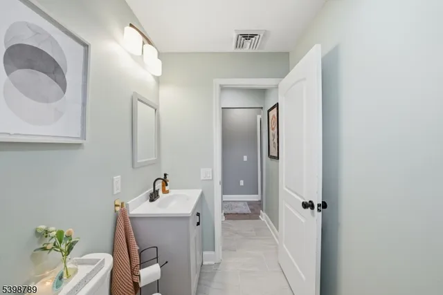 a bathroom with a sink mirror and toilet