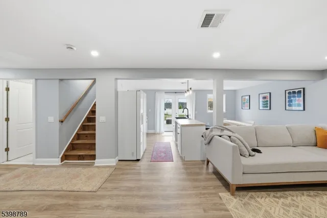 a living room with furniture and a stairs