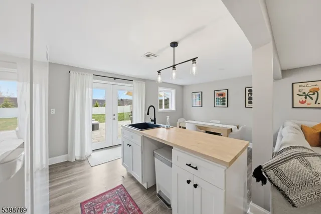 a view of a kitchen counter space a sink and a window