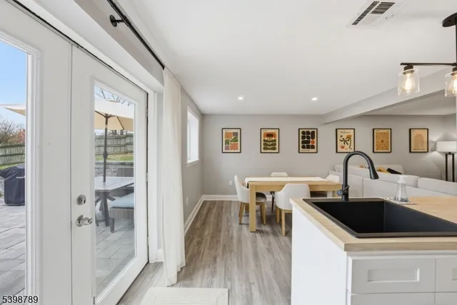 a view of a kitchen area with furniture and wooden floor