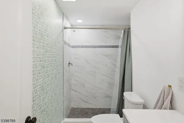 a bathroom with a shower curtain and a toilet