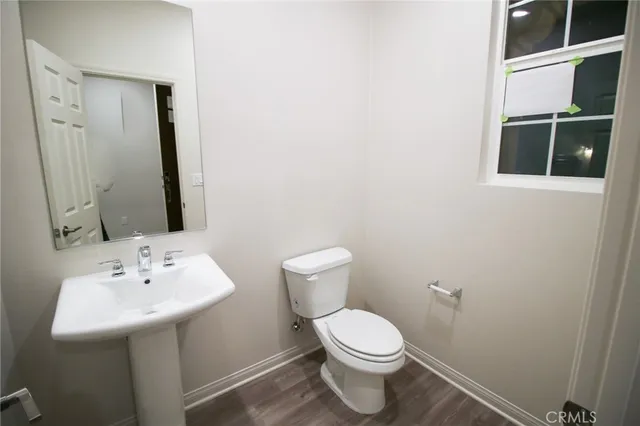 a white toilet sitting next to a bathroom sink