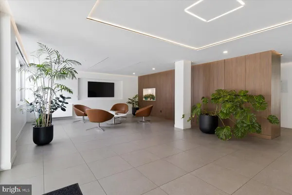 a living room with furniture and flowers