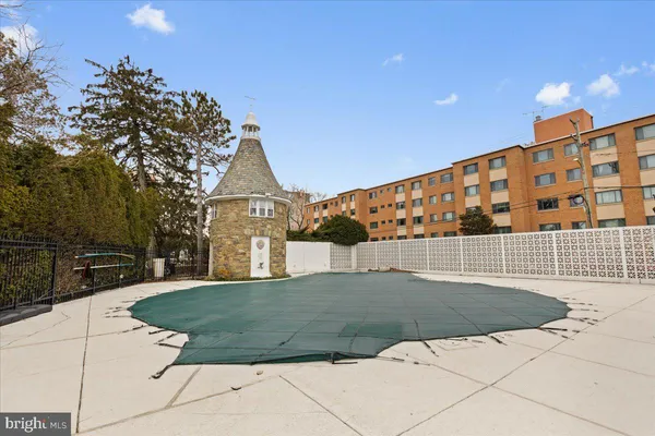 a view of swimming pool with outdoor seating and yard in the back
