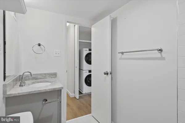 a bathroom with a shower sink and mirror