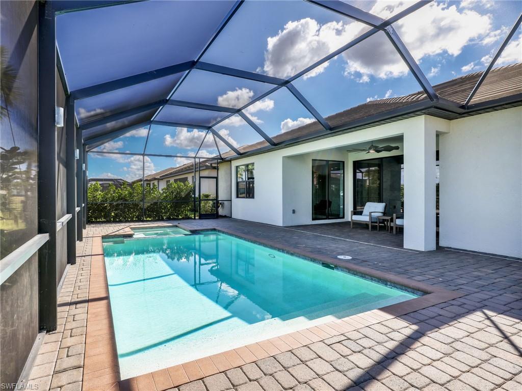 18320 Ridgeline Drive Estero, FL 33928 - Photo 24 of 38 a view of a patio with a table and chairs under an umbrella