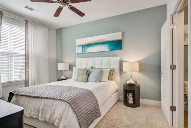 a bedroom with a bed and a large window