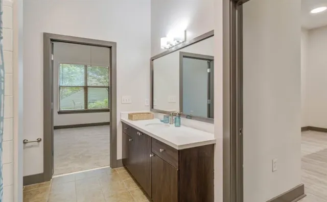 a kitchen with kitchen island a counter top space a refrigerator and a sink