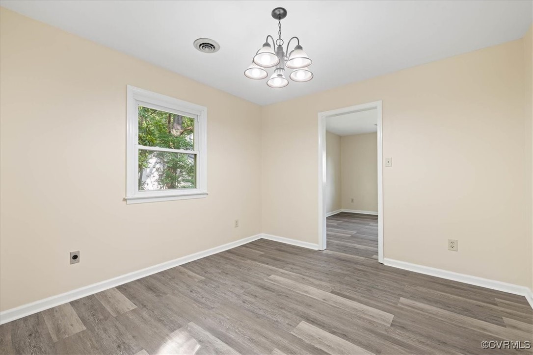 4200 Esposito Place Prince George, VA 23875 - Photo 8 of 29 Empty room with a chandelier, wood finished floors