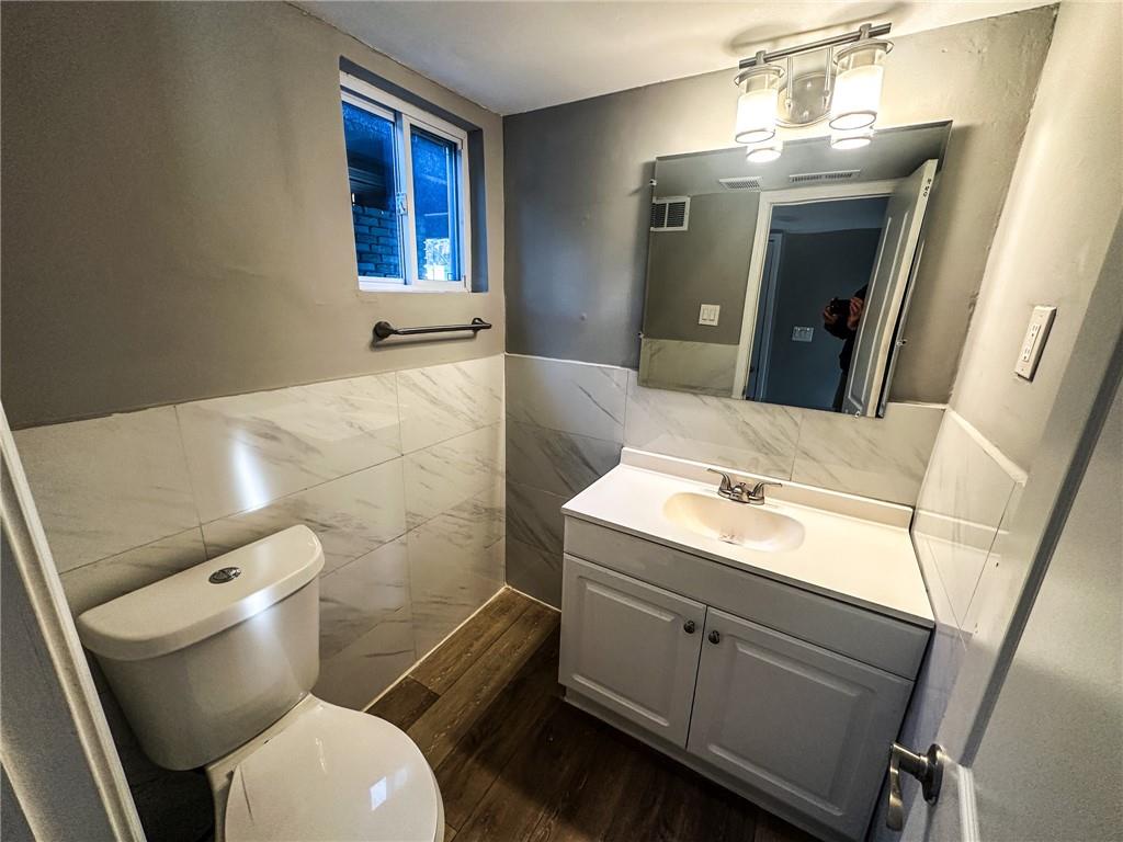 1277 Goodwin Road Northeast Atlanta, GA 30324 - Photo 15 of 21 a bathroom with a sink a toilet and mirror