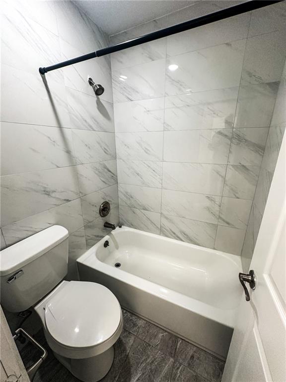1277 Goodwin Road Northeast Atlanta, GA 30324 - Photo 17 of 21 a bathroom with a toilet and a bathtub