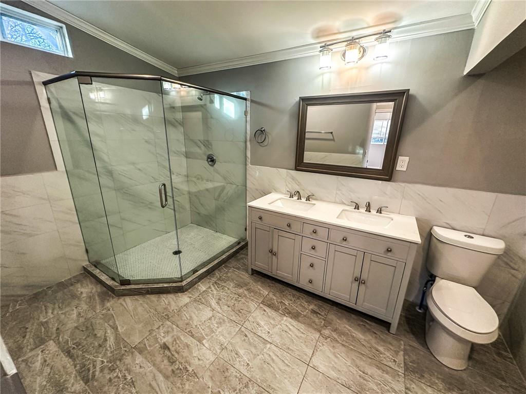 1277 Goodwin Road Northeast Atlanta, GA 30324 - Photo 21 of 21 a bathroom with a double vanity sink mirror and toilet